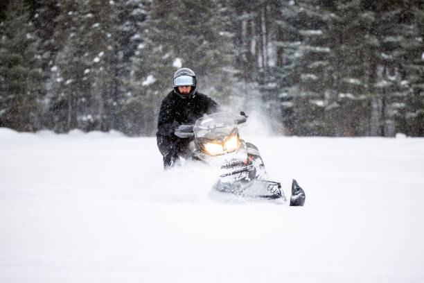 istock Man having fun speeding with a snowmobile through the powder snow 1304500461