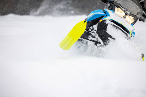 istock Man having fun speeding with a snowmobile through the powder snow 1304500476