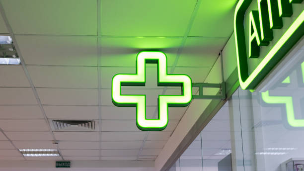 istock Bulb green cross indoor closeup, pharmacy pointer 1304500493