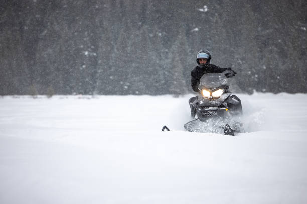 istock Man having fun speeding with a snowmobile through the powder snow 1304500494