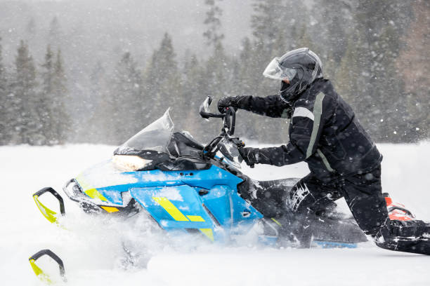 istock Man having fun speeding with a snowmobile through the powder snow 1304501110