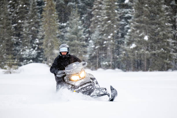 istock Man having fun speeding with a snowmobile through the powder snow 1304501146