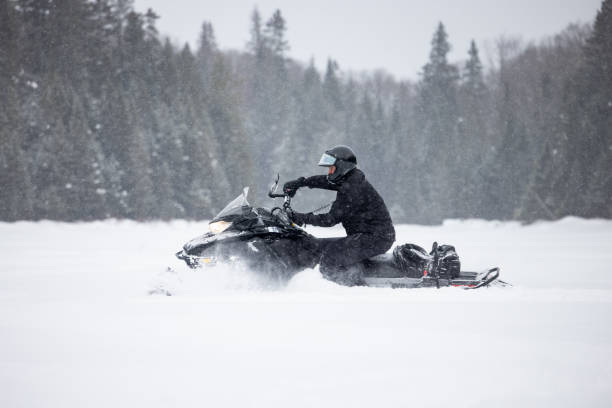 istock Man having fun speeding with a snowmobile through the powder snow 1304501206