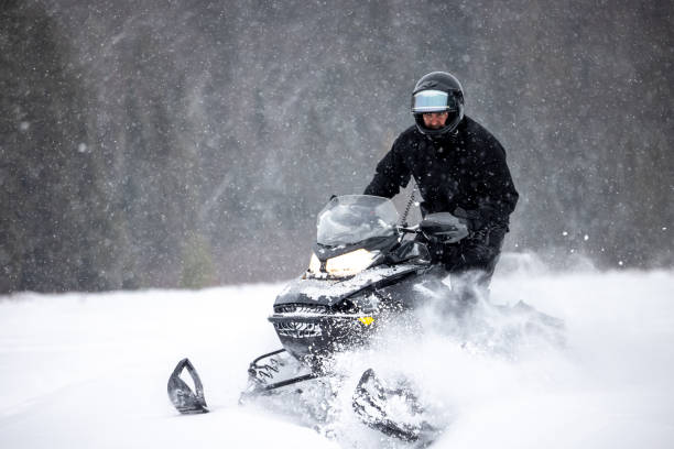 istock Man having fun speeding with a snowmobile through the powder snow 1304501224