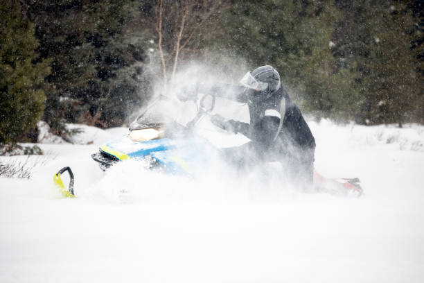istock Man having fun speeding with a snowmobile through the powder snow 1304501253