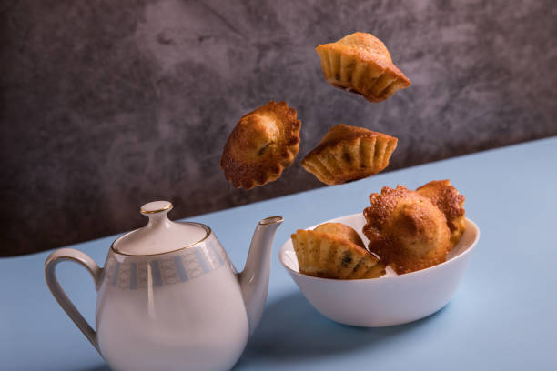 A few homemade muffins fly over the plate. Food Levitation