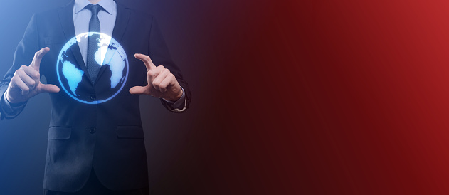 Businessman with protective gesture standing posture hand holding Earth icon , digital globe.