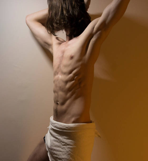istock Defined long hair male model standing in dramatic light 1304503912