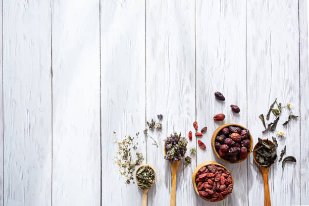 various herbal tea. chamaenerion, chamomile, rose hips, origanum, goji berries  and meadowsweet on white wooden table with copy space. natural herbal medicine. - chinese traditional medicine imagens e fotografias de stock