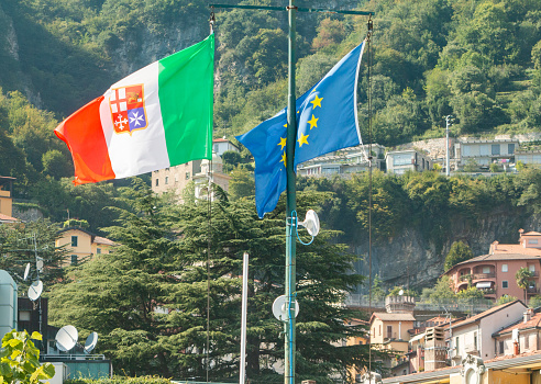 Italian Flag on Lake Como in Lombardy, Italy, with the EU flag behind it