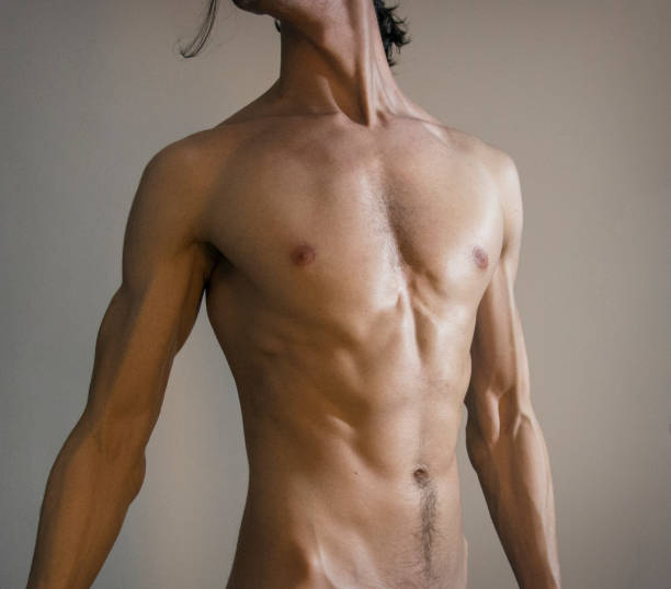 Teenage boy showing off his abs