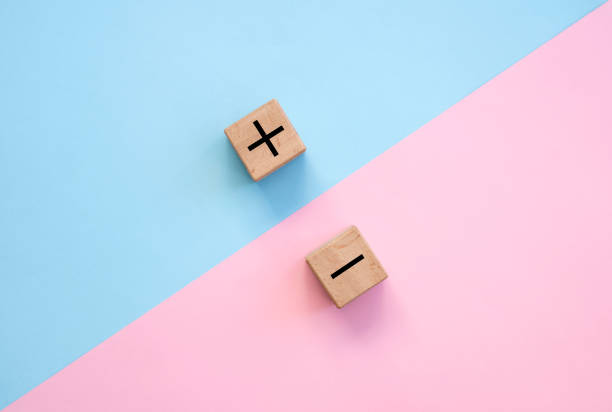 istock Plus and minus signs on a multi-colored background. Positive and negative information 1304507796