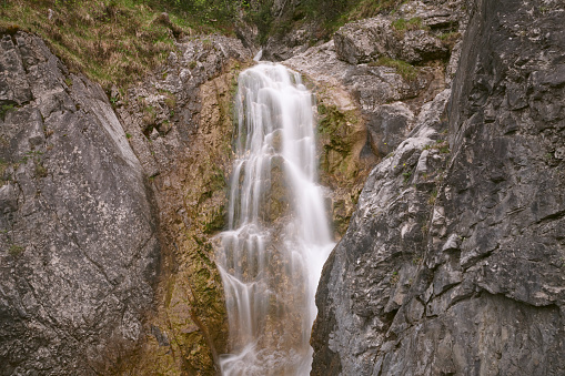 Full frame daylight image of a long exposured waterfall with rocks in foreground in Germany