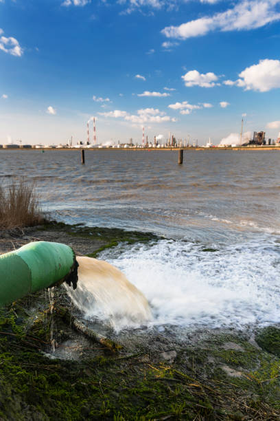 istock Cooling Water Pipe And Refinery At River 1304512296