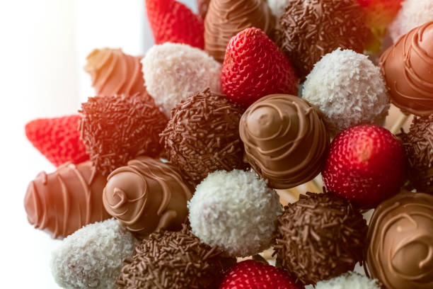 istock fresh strawberries covered with milk chocolate and coconut. 1304512874