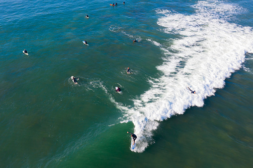 Surfers making the most of the last day of Summer with a surf at a local Mornington Peninsula beach located in Victoria Australia as captured from above.