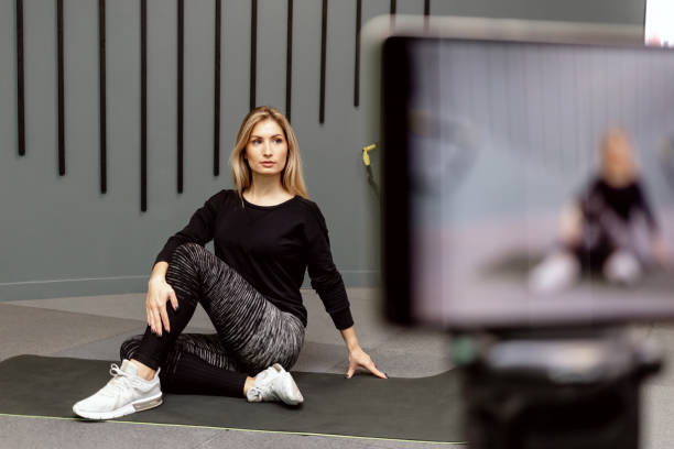Record a video lesson on training sport at gym for the channel on the Internet. Individual fitness on isolation due to the flu virus pandemic.