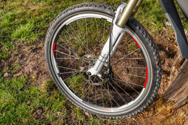 istock Front bicycle fork with oil-air suspension. Visible bicycle wheel, tire and hydraulic disc brake caliper. 1304515364