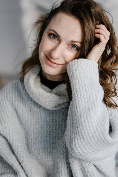istock woman in sweater looking at camera. 1304515402