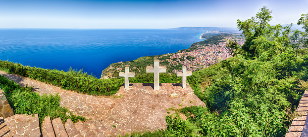 The iconic Three Crosses on the top of Mount Sant'Elia overlooking the town of Palmi on the Tyrrhenian Sea, Italy