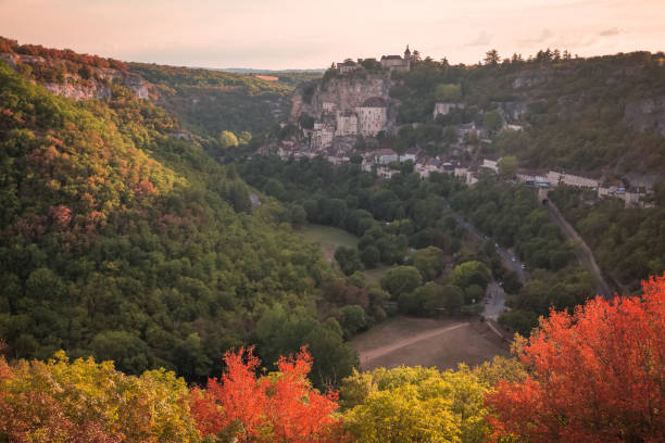 Colourful autumn view of the French medieval hilltop village of Rocamadour, France in the Dordogne Valley with golden sunset or sunrise light.