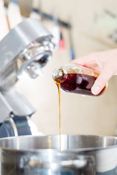 istock Cook pours the syrup into the mixer. Cooking 1304516905