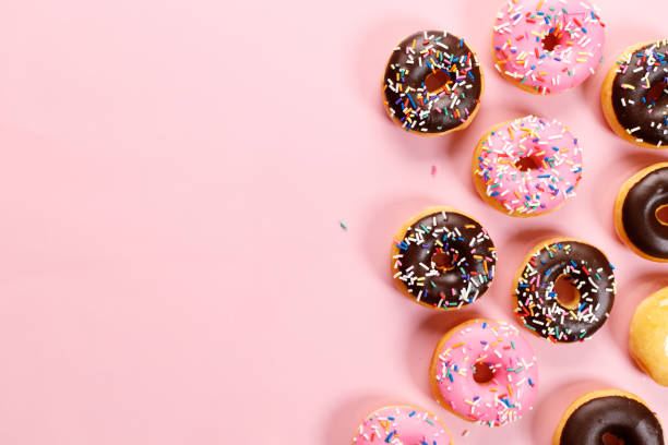 istock colorful donuts  on pink background 1304518122