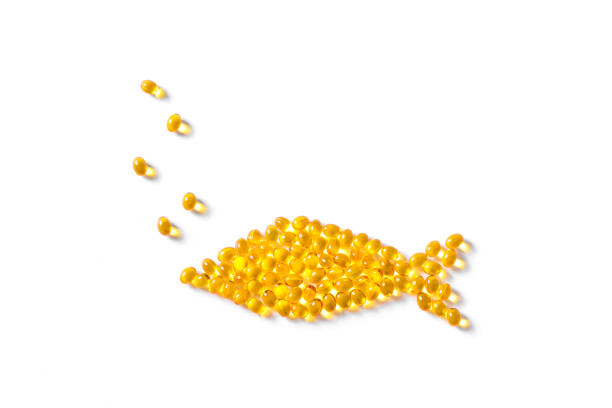 Omega 3 fish oil capsules Omega 3 fish oil capsules (softgels) in shape of fish. Yellow softgels isolated on white, top view, copy space. animal liver stock pictures, royalty-free photos & images