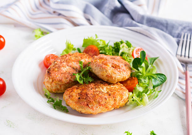 Meatballs with cabbage. Lazy cabbage rolls with fresh salad on light background. Russian cuisine.