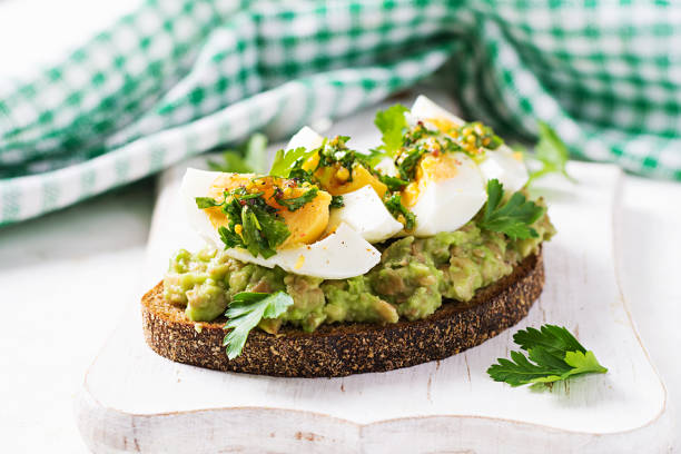 istock Vegetarian breakfast. Sandwich with avocado puree and boiled eggs.  Healthy breakfast or lunch. 1304519890