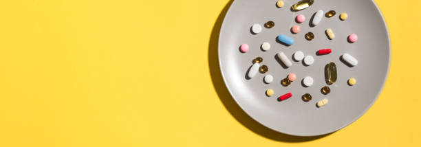 istock Vitamin pills and supplements as food on plate 1304520005