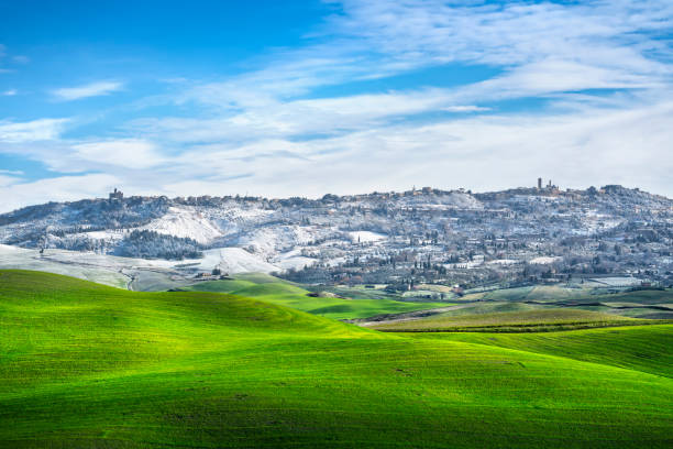Volterra snowy town and rolling hills in winter. Tuscany, Italy Volterra snowy town and rolling hills in winter. Pisa province, Tuscany, Italy, Europe. wintry landscape january december landscape stock pictures, royalty-free photos & images