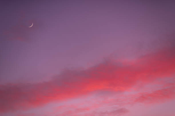 istock Sunset with clouds, light rays and other atmospheric effect with New moon 1304520441