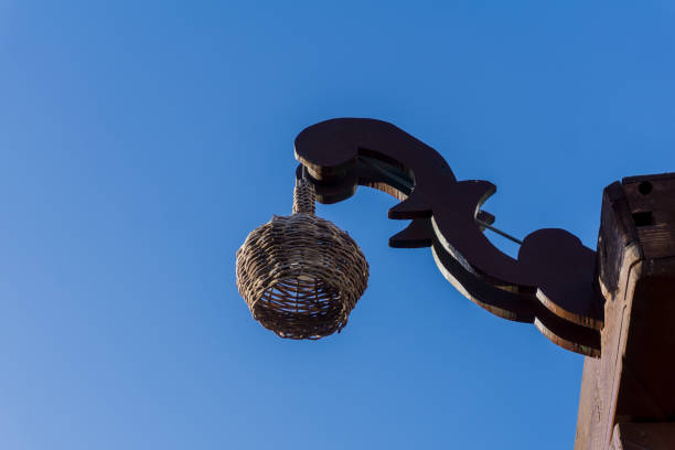 Closeup of a street lamp on a wooden pillar