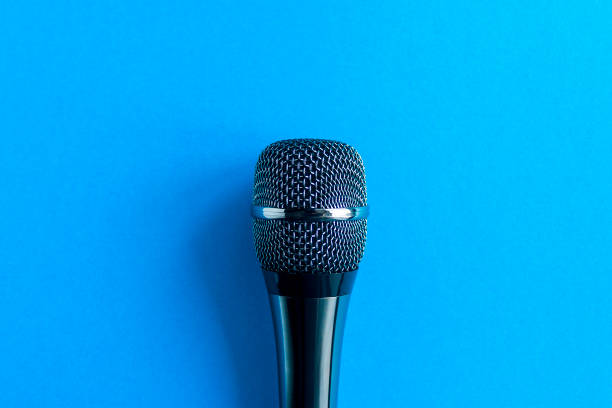 istock Microphone on a colorful blue background close up. Singing, writing music, karaoke online, creativity, vocals concept, symbol. Singing lessons 1304521332