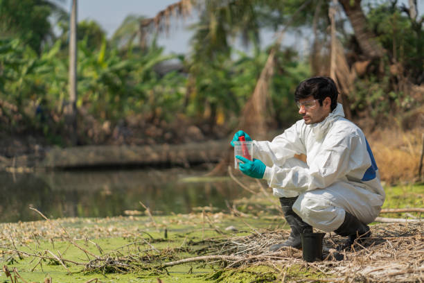 istock A man in full body protective suit collecting samples of water 1304521550