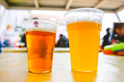 Two cups of craft beer on a street food market