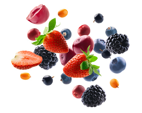 Various berries and fruits on a pink background