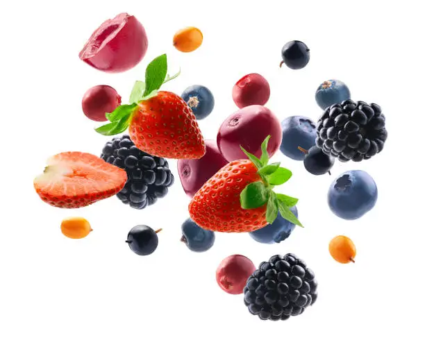 Photo of Many different berries in the form of a frame on a white background