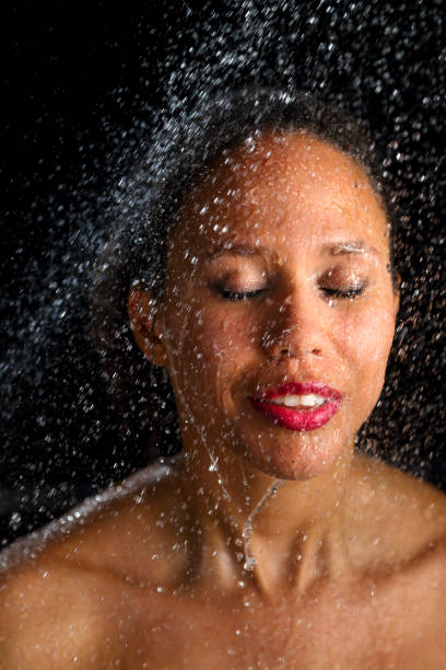 istock African american woman under shower 1304523848