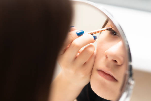 istock Girl does her own makeup with eye shadow 1304524144