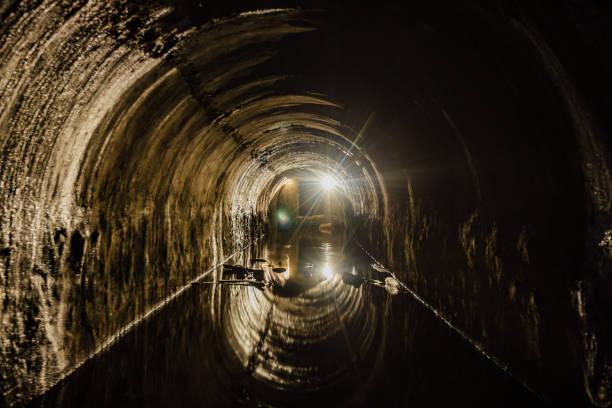 istock Flooded vaulted sewer tunnel with water reflection 1304525241