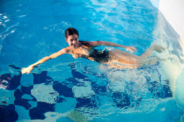 istock Attractive girl in swimming pool 1304526138