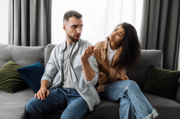 istock Married young couple emotional discuss about something, they having problem. African american woman and caucasian man disagree with each other have a misunderstanding, cant make decision, a quarrel between lovers 1304528338
