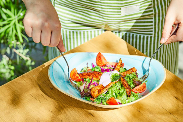 istock Man taking salad with forks from wooden table 1304528437