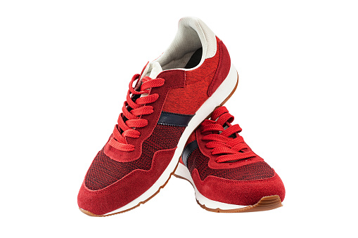 Red jogging sneakers for jogging isolated on white background. Sport shoes. Modern fashion. File contains clipping path.