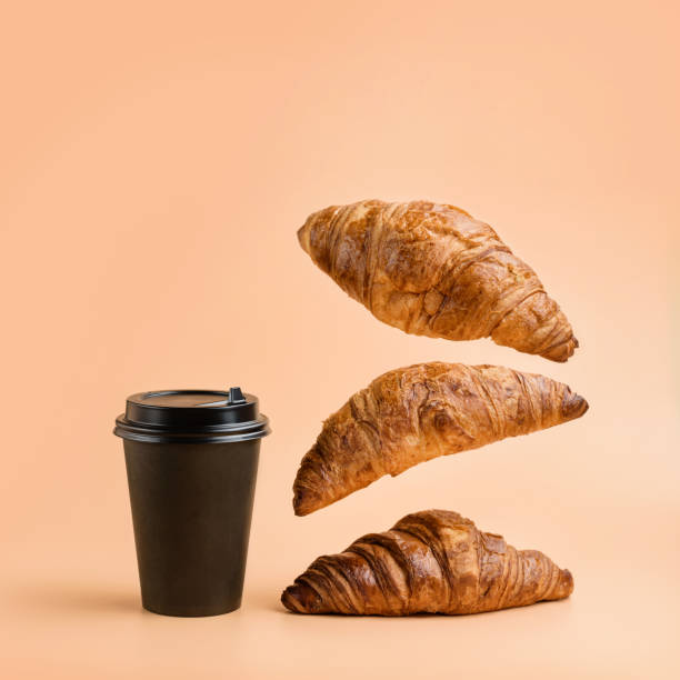istock A glass for hot drinks and three croissants 1304529946