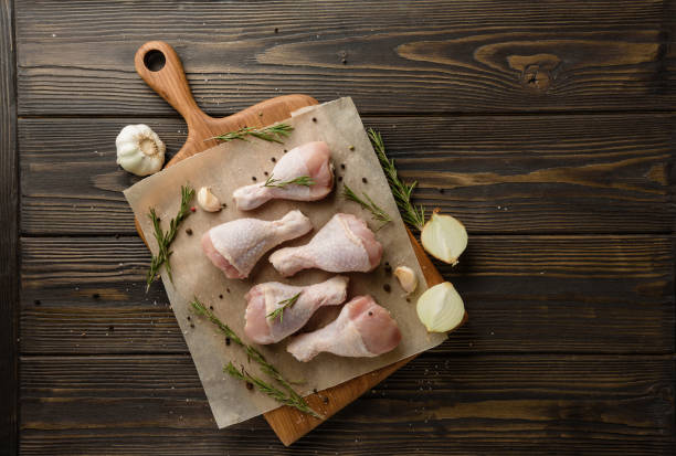istock raw chicken drumsticks with ingredients for cooking on a cutting board 1304529949