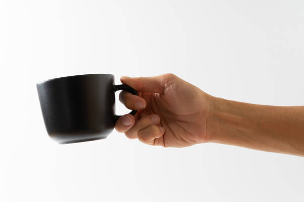 istock hand holding black color cup coffee on white background 1304530966
