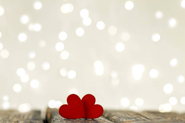 istock Festive postcard. Two red hearts on a light background. 1304530975
